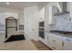 Modern kitchen with black faucet, stainless steel appliances and quartz countertops at 260 S 165Th Ave, Goodyear, AZ 85338