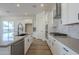 Modern kitchen with white cabinets, stainless steel appliances, and quartz countertops at 260 S 165Th Ave, Goodyear, AZ 85338
