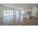 Open concept kitchen with island, white cabinets, and stainless steel appliances at 260 S 165Th Ave, Goodyear, AZ 85338