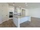 Modern kitchen with island, white cabinets, and stainless steel appliances at 260 S 165Th Ave, Goodyear, AZ 85338
