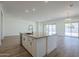Open concept kitchen with island and sliding glass doors to backyard at 260 S 165Th Ave, Goodyear, AZ 85338