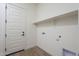 Bright laundry room with shelving and door at 260 S 165Th Ave, Goodyear, AZ 85338