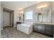 Main bathroom with soaking tub, double vanity, and grey cabinets at 6722 N 190Th Dr, Waddell, AZ 85355