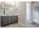 Double vanity bathroom with grey cabinets and modern fixtures at 6722 N 190Th Dr, Waddell, AZ 85355