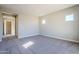 Bright bedroom with plush carpeting and access to hallway at 6722 N 190Th Dr, Waddell, AZ 85355