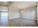 Bright dining room with wood-look floors and chandelier at 6722 N 190Th Dr, Waddell, AZ 85355