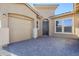 Front entry of new construction home with dark door and paver driveway at 6722 N 190Th Dr, Waddell, AZ 85355