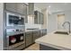 Modern kitchen with stainless steel appliances and gray cabinetry at 6722 N 190Th Dr, Waddell, AZ 85355