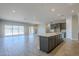 Open kitchen with island, stainless steel appliances, and gray cabinets at 6722 N 190Th Dr, Waddell, AZ 85355