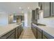 Modern kitchen with gray cabinets, white subway tile, and quartz counters at 6722 N 190Th Dr, Waddell, AZ 85355