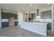 Open concept kitchen with island and gray cabinets at 6722 N 190Th Dr, Waddell, AZ 85355