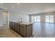 Open kitchen with island, stainless steel appliances, and gray cabinets at 6722 N 190Th Dr, Waddell, AZ 85355