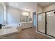 Clean bathroom with double vanity, soaking tub, and shower at 19014 W Ocotillo Rd, Waddell, AZ 85355