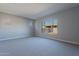 Spacious bedroom with carpeted floors and large window at 19014 W Ocotillo Rd, Waddell, AZ 85355