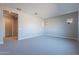 Bright bedroom with carpeted floors and access to hallway at 19014 W Ocotillo Rd, Waddell, AZ 85355