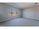 Well-lit bedroom featuring carpeted floors and a window at 19014 W Ocotillo Rd, Waddell, AZ 85355