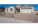 Single story home with light colored exterior and a two-car garage at 19014 W Ocotillo Rd, Waddell, AZ 85355