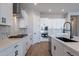 Modern kitchen with white cabinets, quartz countertops, and stainless steel appliances at 19014 W Ocotillo Rd, Waddell, AZ 85355