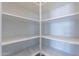 Bright white pantry with ample shelving for storage at 19014 W Ocotillo Rd, Waddell, AZ 85355