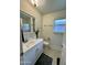 Bathroom with a bright window, a vanity with mirror and a walk-in shower at 10931 W Peoria Ave, Sun City, AZ 85351