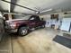 Spacious garage featuring ample storage space and a parked pickup truck at 10931 W Peoria Ave, Sun City, AZ 85351