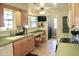 Cozy kitchen area with a built-in desk, natural light, and adjacent laundry room at 10931 W Peoria Ave, Sun City, AZ 85351