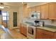 Well-lit kitchen boasts wood cabinetry, modern appliances, and a convenient pantry at 10931 W Peoria Ave, Sun City, AZ 85351