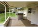 Cozy covered patio with stainless steel BBQ grill and view of the landscaped yard at 10931 W Peoria Ave, Sun City, AZ 85351