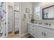 Clean bathroom with white subway tile, a bathtub, and modern vanity at 18223 W Rancho Ct, Litchfield Park, AZ 85340