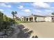 Home exterior showcasing a large backyard and spacious driveway at 18223 W Rancho Ct, Litchfield Park, AZ 85340