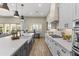 Modern kitchen with white cabinets, island, and gas cooktop at 18223 W Rancho Ct, Litchfield Park, AZ 85340