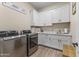 Bright laundry room with white cabinets, LG washer and dryer, and ample counter space at 18223 W Rancho Ct, Litchfield Park, AZ 85340