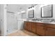 Well-lit bathroom features a dual sink vanity and a walk-in shower at 20980 N Sweet Dreams Dr, Maricopa, AZ 85138