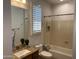 Well-lit bathroom featuring a granite countertop, modern fixtures, and a shower over the tub at 20980 N Sweet Dreams Dr, Maricopa, AZ 85138