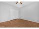 Empty bedroom featuring modern ceiling fan, hardwood floor, and closet at 20980 N Sweet Dreams Dr, Maricopa, AZ 85138