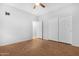 Simple bedroom featuring ceiling fan, hardwood floor, and closet at 20980 N Sweet Dreams Dr, Maricopa, AZ 85138