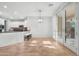 Bright breakfast nook adjacent to the kitchen, featuring a stylish light fixture and sliding glass doors at 20980 N Sweet Dreams Dr, Maricopa, AZ 85138