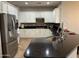 Well-lit kitchen featuring white cabinets, stainless steel appliances, and a dark countertop island at 20980 N Sweet Dreams Dr, Maricopa, AZ 85138