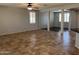 Open-concept living area with tiled flooring, neutral walls, and a modern light fixture at 20980 N Sweet Dreams Dr, Maricopa, AZ 85138