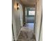 Hallway with modern floors leading to carpeted bedroom at 17218 N Melissa Ln, Surprise, AZ 85374