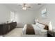Bright bedroom with modern furniture, a stylish bed, and an elegant area rug creating a cozy atmosphere at 40095 W Hensley Way, Maricopa, AZ 85138