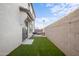 Private backyard with patio, artificial turf, and string lights, creating an inviting outdoor living space at 3930 S 58Th Ln, Phoenix, AZ 85043