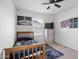 A bedroom with a wooden bed frame, ceiling fan, dresser and wall art at 3930 S 58Th Ln, Phoenix, AZ 85043