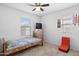 Neutral bedroom with a ceiling fan, window, and -friendly decorations for a cozy and personalized space at 3930 S 58Th Ln, Phoenix, AZ 85043