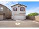 Charming two-story home with a spacious two car garage, enhanced by red window shutters and a paved driveway at 3930 S 58Th Ln, Phoenix, AZ 85043