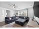 Cozy living room featuring tile floors, neutral decor, and a large sectional sofa at 3930 S 58Th Ln, Phoenix, AZ 85043