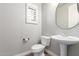 Elegant half bathroom features a pedestal sink, oval mirror and window with privacy shutters at 9301 E Desert Arroyos --, Scottsdale, AZ 85255