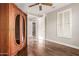 Bedroom featuring hardwood floors, shuttered windows, wooden ceiling fan, and large armoire at 9301 E Desert Arroyos --, Scottsdale, AZ 85255