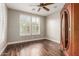 Bedroom with hardwood floors, shuttered windows, wooden ceiling fan, and large armoire at 9301 E Desert Arroyos --, Scottsdale, AZ 85255