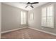 Bright bedroom with neutral walls, carpet, shuttered windows and modern ceiling fan at 9301 E Desert Arroyos --, Scottsdale, AZ 85255